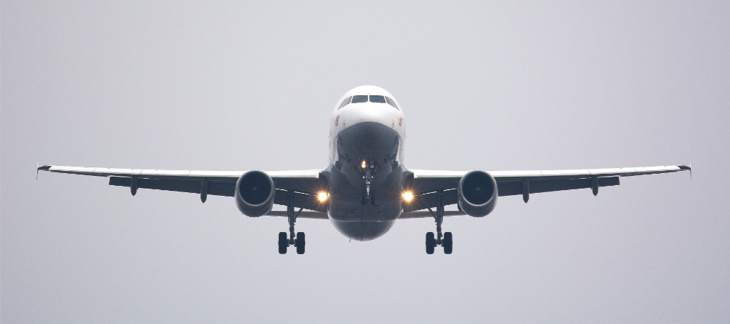 plane flying in front of gray background flying in 2023