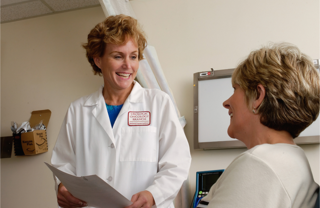 doctors speaking with patient in hospital